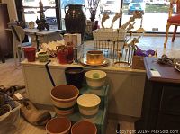 Wide view of lot showing flower pots, metal baskets, diffusers, gold chargers, and wooden steps