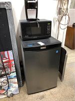 Photo showing the stacked setup with a Keurig coffee brewer on top of a Danby microwave, which is sitting on a Danby mini fridge.