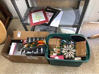 Overall view of boxes containing multi-colored and white LED string lights, greeting cards, and candles with remotes.