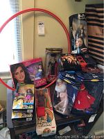 Wide view showing hula hoop, Brooke Shields doll, Bionic Woman box, Barbies, Charlie’s Angels set, Buffy figures
