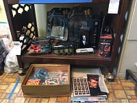 Overview of X-Files collectibles including sealed Scully and Mulder action figures with several other items on shelf.