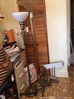 Two floor lamps and other items in a corner with visible Capiz shell lamp shade and vintage desk lamp with fluorescent tube