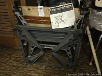 Vintage Black & Decker Workmate Type 2 workbench in folded position with attached instruction manual.