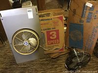 Photo of Lakewood Model 200 20-inch portable electric fan with original packaging and two other fans nearby