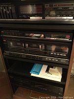 Photo showing Fisher Double Cassette Deck and stereo controls inside cabinet