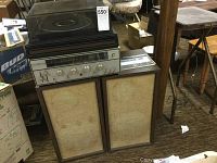 Full vintage KLH stereo system showing two speakers and the stereo receiver on top, with manuals visible on side.
