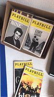 Box containing Playbill programs with covers 'Nine' and 'Lost in Yonkers'