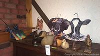 Photo showing all items including duck decoys on base, and animal face hangers in back