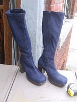 Full view of the two sparkly denim boots standing upright showing tall shaft and block heels.