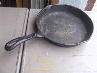 Top and inside view of cast iron skillet showing cooking surface and handle