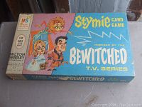 Top view of Milton Bradley Stymie card game box with cartoon characters from Bewitched TV series on cover.
