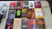 15 books arranged in 3 rows, featuring titles on magic, UFOs, the occult and ancient civilizations.