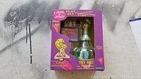 Front view of unopened I Dream of Jeannie play set box showing musical lamp base and additional pieces inside.