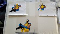 Three Wolverine animation cels showing front, side, and back views all featuring Wolverine holding a steering wheel.