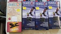 Full view of three boxed packages of TravelSox compression socks showing front packaging design with features and graphics.
