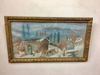 Full view of the pastel painting displaying a winter rural scene with cabins and trees inside an ornate carved antique frame.
