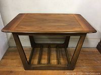 Front three-quarter view showing tabletop, legs and slatted lower shelf