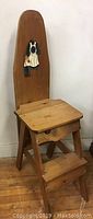 Full view of the solid pine multi-functional stepladder with a back panel showing the handpainted tole design of a woman and child.