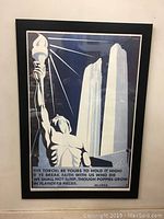 Full framed poster showing figure holding torch and twin tall white monuments in background.