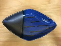 Top view showing diamond shape and blue and black glaze with textured accents.