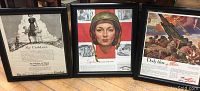 Photo showing the full set of three framed war advertisement posters with visible titles and imagery.