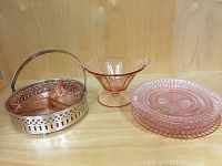 All items in the lot displayed, including silverplate holder with divided bowl, footed bowl, and four plates.