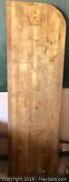 Solid wood butcher block top showing natural wood grain and rounded edge.