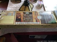 Box showing water damage and product labeling with images of the wooden wine rack.