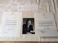 Photo showing the set spread out on a flat surface: two letters, envelope, and black and white photo of Jean Chrétien