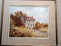 Framed oil painting of a stone house in an autumn landscape with trees and pathway, titled 'Heritage Home'