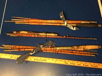 Three disassembled bamboo rod sections bundled and laid flat showing full length segments