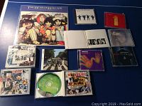 Overview photo showing all the Beatles vinyl and CD items laid out flat on a blue surface.