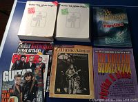 Full view of all six books and magazines in the lot showing titles and covers