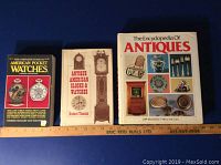 Three antique reference books side by side showing titles and cover designs.