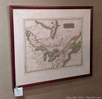 Framed antique map hung on a wall showing 'Canada and Nova Scotia' with hand-colored details.