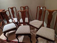 Set of six mahogany dining chairs including two armchairs with floral upholstery