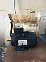 Front side of Leeson motor with original box in background.