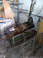 Bandsaw head, base, and upright frame in workshop environment