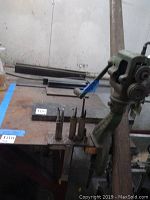 Niagara MST WKS cast iron edger mounted on wooden workbench with metal tools and granite slab nearby.