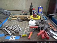 Calipers, wrenches, Marson thread setter, hand planes, clamps, drill bits and other tools arranged on a table surface.