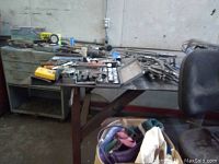 Photo showing metal industrial table top with various hand tools and wrenches spread out, showing condition and scale.