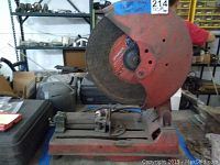 Full side view of the red Diablo metal cut off saw set on a shelf in workshop environment.