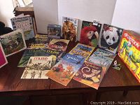 Wide view showing all items including books, magazines, puzzle, LEGO, and the Operation game box