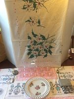 Image showing vintage floral hand-painted lattice work china plate, clear glass punch cups on pink tray, silver plate utensils, pewter butterfly napkin rings, and two vintage floral/ geometric patterned tablecloths.