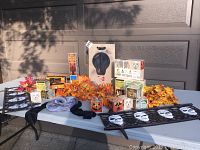 Full set of Halloween decorations including skull yard fences, stacking blocks, lamp in box, garlands and lights displayed on table