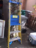 Side view of the Werner fiberglass 9-foot podium ladder showing its structure and steps.