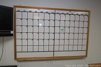 Large dry erase calendar board with wooden frame showing two months and days grid