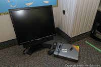 Photo of a Dell AX510 monitor, remote, Bluetooth USB stick, and Q See security system DVR on carpeted floor.