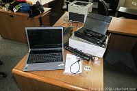 Photo showing Dell Studio 1536 laptop, Edson Workforce WF100 WiFi printer and Xerox Travel Scanner 100 on wood desk in office environment