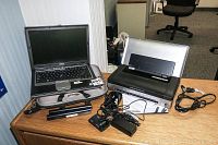 Dell Latitude PP18L Laptop alongside HP Officejet 100 Mobile Printer and accessories on a wooden desk